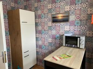 a kitchen with a counter with a microwave on a wall at familienfreundliche Ferienwohnung Maria in Duderstadt