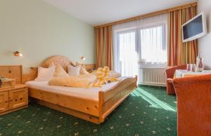 Postel nebo postele na pokoji v ubytování Hotel Sporthof Austria