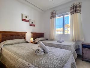 sypialnia z dwoma łóżkami i oknem w obiekcie Ribera Beach 3 - 2706 w mieście Mar de Cristal +36 zdjęć