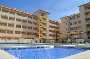 a building with a swimming pool in front of a building at Ribera Beach 3 - 0809 in Mar de Cristal