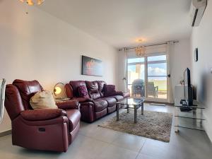 a living room with a couch and a table at Las Terrazas Golf 4209 - Max in Roldán
