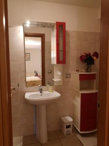 een badkamer met een wastafel en een spiegel bij A Due Passi Dal Mare B&B in Numana