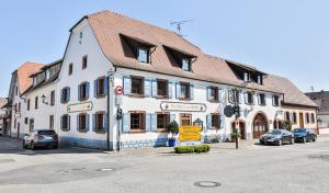 a white building on the corner of a street at Hotel-Gasthaus "Krone" in Bötzingen