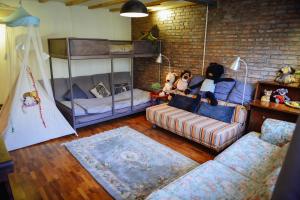 a living room with a couch and bunk beds at Fuxishan East Inn in Huairou