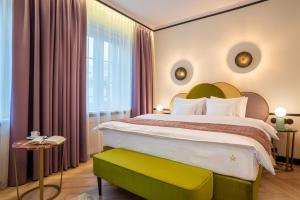 een slaapkamer met een groot bed met een groen hoofdeinde bij SleepWell Boutique Apartments in Warschau