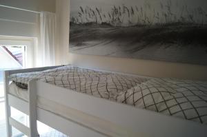 a bed in a bedroom with a painting on the wall at Haus am See in Storkow