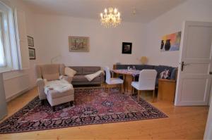 a living room with a couch and a table and chairs at Stieglerhof KG in Illmitz
