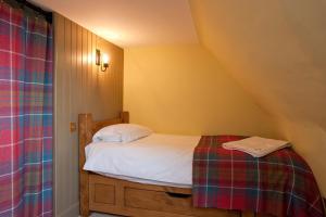 a bedroom with a bed in a attic at Balnakeil House in Balnakeil