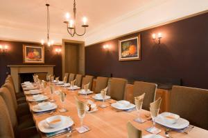 a conference room with a long table and chairs at Balnakeil House in Balnakeil