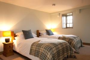 a bedroom with two beds and a window at Balnakeil House in Balnakeil