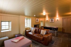 a living room with a couch and a pool table at Balnakeil House in Balnakeil