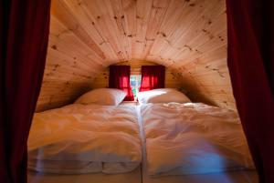 a bedroom with two beds in a wooden room at Harmony beim Holzschnitzer in Dreis-Brück