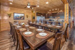 a dining room with a large wooden table and chairs at SmokyStays 10 Bedroom Cabin in Pigeon Forge