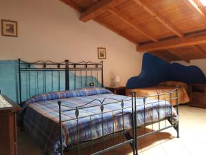 una camera da letto con letto dotato di struttura in metallo nero di Affittacamere "Nel Paese di Alice" a Borghetto di Vara