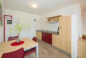 a kitchen with a table with a vase on it at Gasserhof Garni & Apartment in Schenna