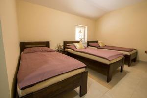 A bed or beds in a room at Reštaurácia-penzión ALTANA Még 37 kép