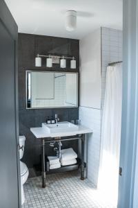 a bathroom with a sink and a mirror at The George in Montclair +21 photos