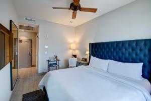 a bedroom with a large bed and a ceiling fan at The Plymouth South Beach in Miami Beach