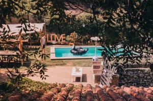 a swimming pool with a swan in a yard at Sintra Center Guest House Escape to Nature in Sintra
