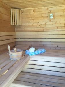 a wooden sauna with a bowl and a blanket at Villa Colombier in Fréjus