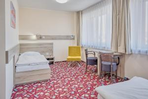 Ένα ή περισσότερα κρεβάτια σε δωμάτιο στο Hotel Arena