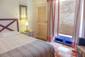 a bedroom with a bed and a large window at Casa Vale Del Rei in Tavira +19 photos