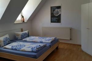 a bedroom with two beds with blue sheets at Gemütlich in Bacharach in Bacharach