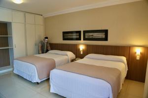
A bed or beds in a room at Arituba Park Hotel
