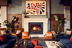 a living room filled with furniture and a fire place at The Hoxton, Chicago in Chicago