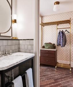 a bathroom with a sink, mirror and bath tub at The Hoxton, Chicago in Chicago