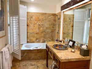 a bathroom with a tub and a sink and a bath tub at Casa Culinaria - The Gourmet Inn in Santa Fe +184 photos