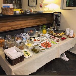 a table with many plates of food on it at Bałtycka44 Rooms & Apartments in Olsztyn