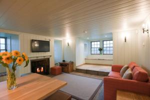 a living room with a couch and a fireplace at Balnakeil House in Balnakeil