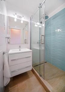 a bathroom with a sink and a glass shower at Illy Apartman in Eger