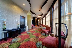 a hotel lobby with a carpeted floor and chairs at Holiday Inn Arlington Northeast, an IHG Hotel in Arlington