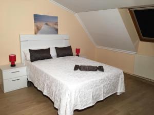 a bedroom with a bed with a bow tie on it at Villa De Foz in Foz