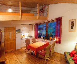 a kitchen and dining room with a table and chairs at En Raußel in Windeck