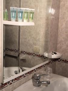 uma casa de banho com um lavatório e um espelho em Villa De Foz em Foz