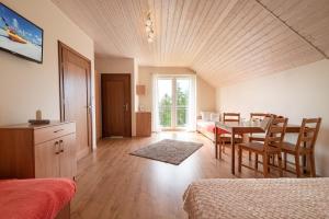 a bedroom with a table and a dining room at Pokoje VIERA in Karwia