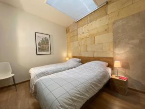 Ένα ή περισσότερα κρεβάτια σε δωμάτιο στο Appartement Saint Emilion