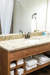 a bathroom with a sink and a mirror at Sawtelle Mountain Resort in Island Park