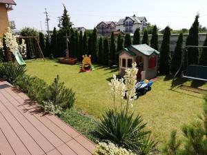 a small yard with a playground and a play set at Pokoje VIERA in Karwia