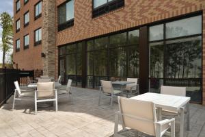 a patio with tables and chairs in front of a building at Holiday Inn Express Atlanta SW - Newnan by IHG in Newnan