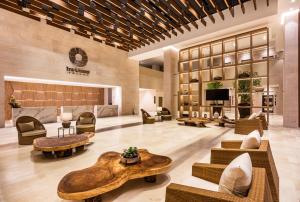 a lobby with couches and tables and a television at Irotama Resort in Santa Marta