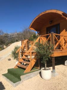 a wooden cabin with a staircase leading to a door at Roulotte de Florette in Tourrettes-sur-Loup
