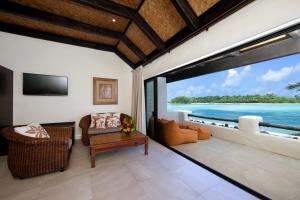 a living room with a view of the ocean at Pacific Resort Rarotonga in Rarotonga