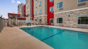 a swimming pool in front of a building at Executive Residency by Best Western Corpus Christi in Corpus Christi