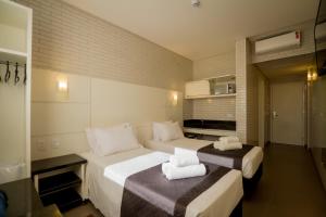 Postel nebo postele na pokoji v ubytování Hotel Confiance Barigui + 11 fotografií