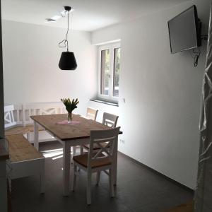 a dining room with a wooden table and chairs at Gästehaus Engelgarten in Estenfeld +2 photos