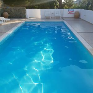 a swimming pool with blue water in a backyard at Villa Elpiniki in Troulos